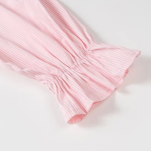 Detailed view of pink and white striped shirt cuff with elasticated ruffled edges