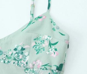 Detail of mint green floral midi dress with adjustable straps and invisible side zipper