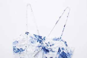Close-up of blue floral print summer dress with ruched bust and fine spaghetti straps