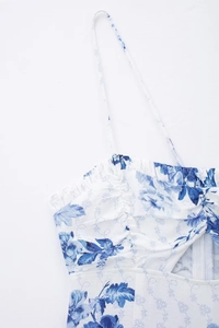 Detail shot of summer floral dress featuring bust ruching and thin spaghetti straps