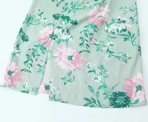 Detail of floral linen blend dress featuring pink flower print and side slit hem