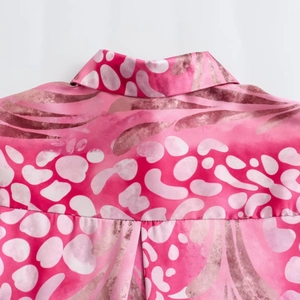 Detail of pink abstract leopard print blouse showing collar and silk fabric texture