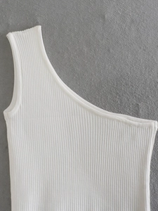 Macro detail of white ribbed knit fabric on a sexy one-shoulder slim fit top