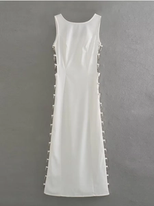 Detail view of side cut-out with silver metal ring decor on white sleeveless dress