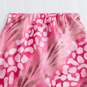 Detail of high waist elastic band and vibrant pink abstract floral print on midi skirt