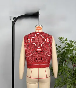 Detail of red cotton paisley print vest showing intricate white floral back pattern