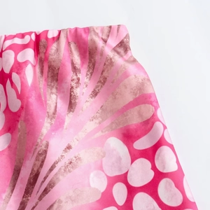 Detail of pink floral print skirt showing elastic waist and smooth fabric texture