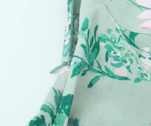 Detail of invisible zipper and floral linen-blend fabric texture on summer midi dress