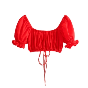 Detail of red off-shoulder crop top featuring puff sleeves and elastic drawstring hem