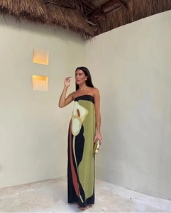 Detail of summer strapless maxi dress featuring bold calla lily floral print and silky fabric