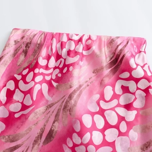 Close-up of elastic waistband on pink leopard print midi skirt with smooth texture