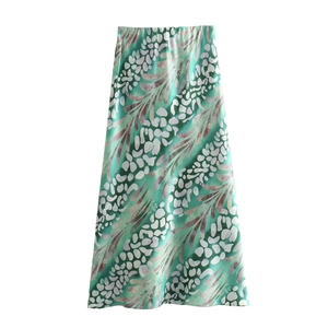 Detailed view of mint green A-line midi skirt with abstract white floral patterns
