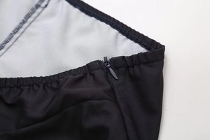 Detail shot of invisible zipper and stitching on a black printed summer tube dress