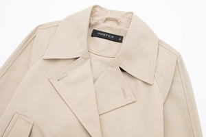 Detail von Reverskragen und Markenetikett auf beiger Baumwoll-Twill-Jacke aus hoher Dichte