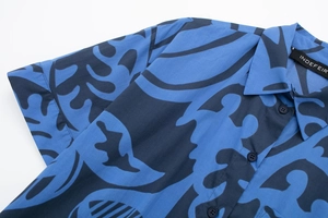 Close-up of tropical leaf print shirt with button detail and branded inner collar tag