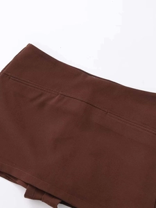 Detailed close-up showing precise double stitching on a high-waisted dark brown skirt