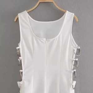 White sleeveless slim fit dress featuring side cut-outs and silver metal ring decorations