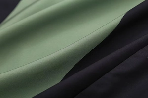 Close-up of dual-tone satin fabric showing elegant drape and smooth texture on a summer dress