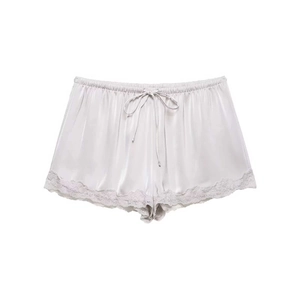Macro detail of silver satin shorts showing elastic waistband and delicate lace trim