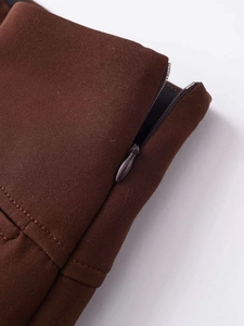 Detailed close-up showing high-quality invisible zipper and neat stitching on brown skirt