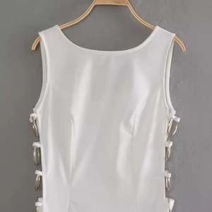 White sleeveless slim dress with side cut-outs and stylish metal ring decorations
