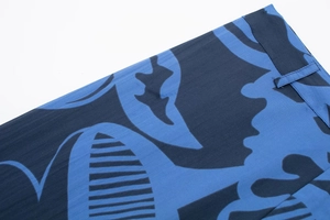 Detailed macro view of high-quality blue and black abstract geometric print fabric with belt loops