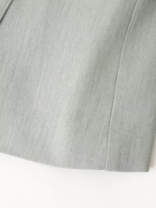 Close-up of premium sage green woven fabric with smooth stitching and fine texture