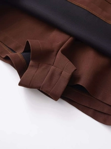 Detail shot of brown skirt fabric with integrated black safety shorts and neat stitching