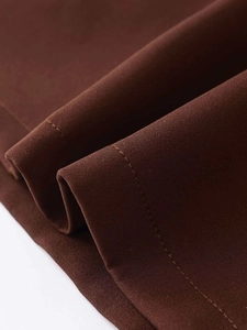 Detailed macro view of high-density brown twill fabric with precision stitching