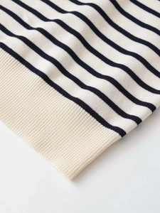 Close-up of fine knit texture and ribbed hem on striped short sleeve sweater
