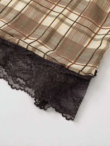 Détail de tissu à carreaux jaunes avec bordure en dentelle noire de haute qualité et festons