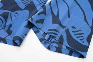 Detail of blue and black floral pattern fabric with high-quality stitching and breathable texture