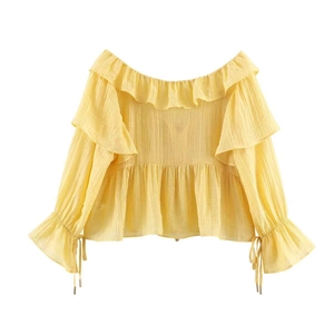 Detail of yellow off-shoulder top featuring ruffled neckline and bell sleeves with drawstrings