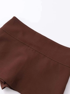 Detailed macro shot of chocolate brown skirt waistband with precise double-needle stitching