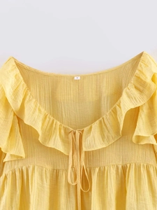 Detail of yellow pleated chiffon fabric with ruffle texture and drawstring V-neck