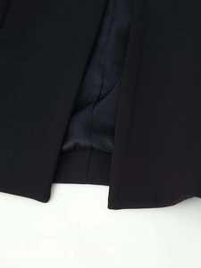 Detail of a black blazer with a clean back vent and high-quality inner lining