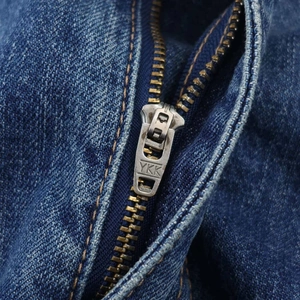 Detail of high-quality YKK metal zipper on vintage high-waist balloon denim jeans