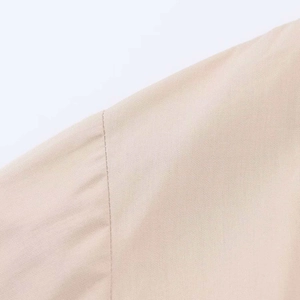 Close-up of beige twill midi dress showing high-quality stitching and fabric texture