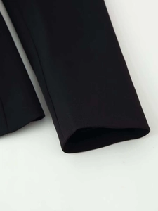 Close-up of the high-quality black twill fabric and sleek cuff detail of the blazer jacket
