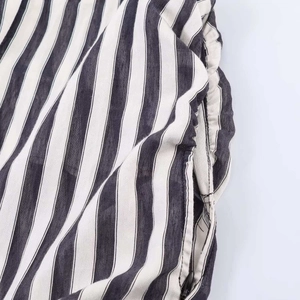 Detailed close-up of vertical striped fabric with a high-quality invisible side zipper