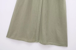 Macro detail of the gray-green linen blend dress hem showing fine stitching and texture