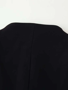 Detailed close-up of the shoulder seam on a structured black blazer with premium stitching