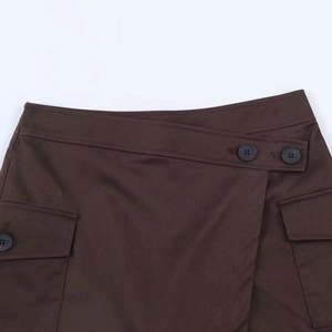 Minimalist high-waisted dark brown asymmetrical skort with cargo pockets and double buttons