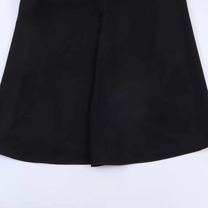 Detail of the high-quality black fabric texture and clean hemline on this striped dress
