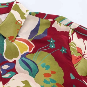 Close-up of floral satin shirt showing notched lapel collar and vintage botanical print