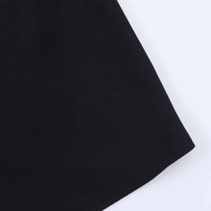 Close-up of high-density black woven fabric showing smooth texture and neat hemline seams