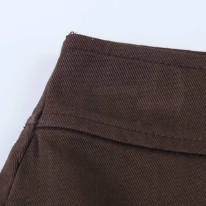 Detailed close-up of dark brown high waist skirt shorts with visible twill fabric texture