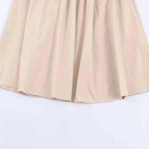 Close-up of the pleated hem on a khaki midi dress showing high-quality stitching detail