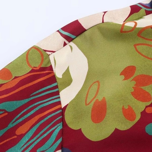 Macro detail showing floral print patterns and high-quality stitching on satin shirt fabric