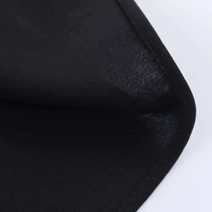 Macro detail of the high-quality black fabric texture and neat edge stitching on the dress
